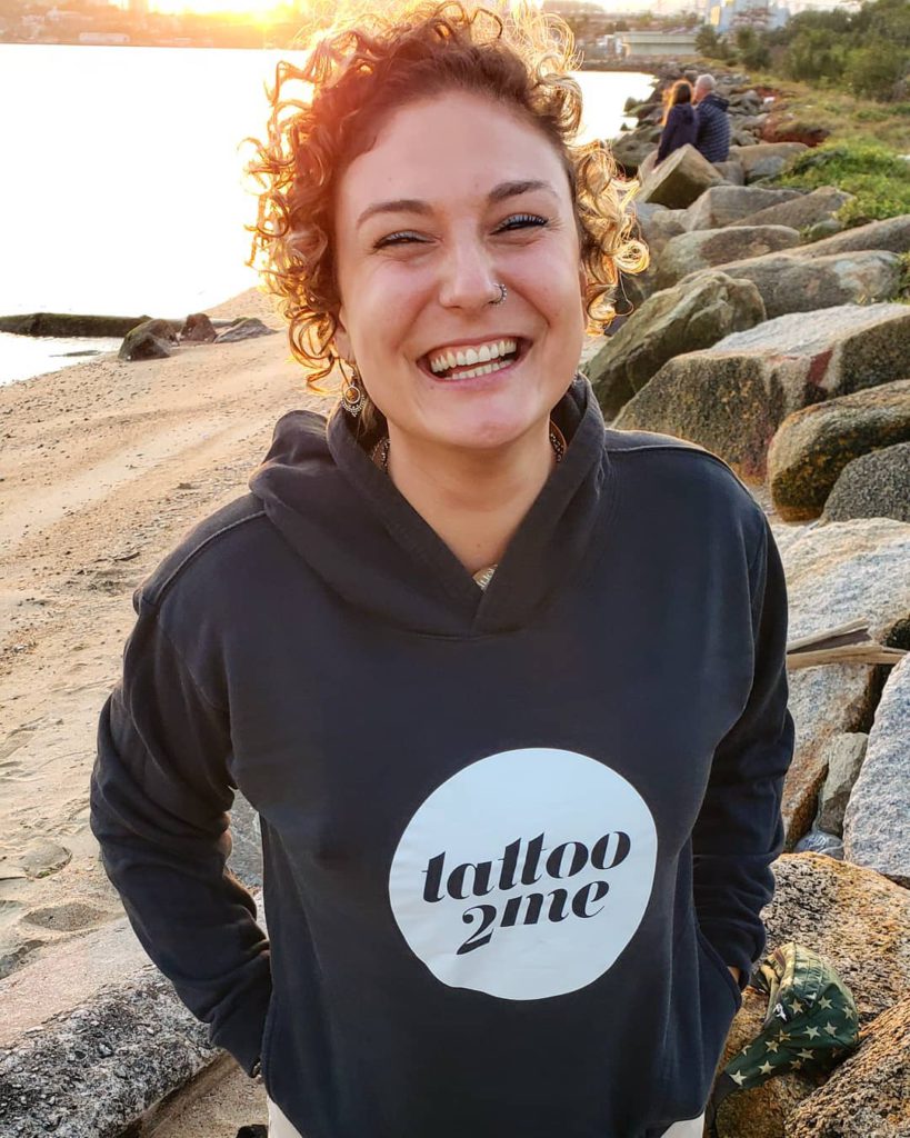 Nicole sorrindo com o moleton do tattoo2me